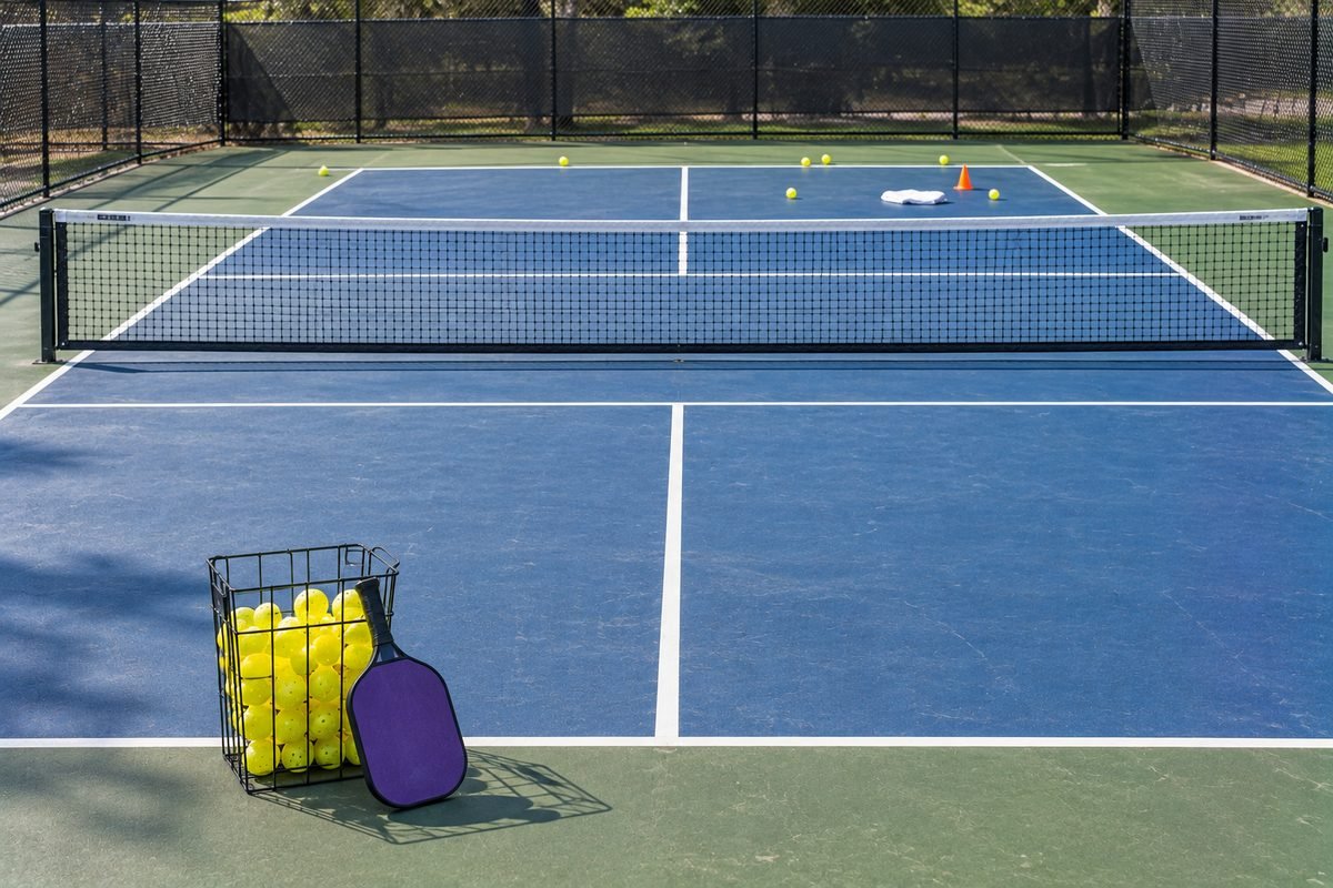 Serve to targets pickleball drill with a towel target and a basket of balls